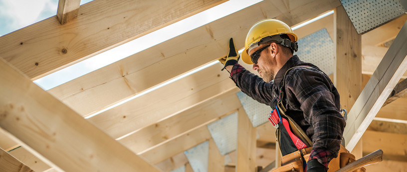 Zimmermannn im Dachstuhl aus Holz